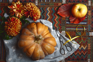 autumn background with pumpkin, leaves and flowers