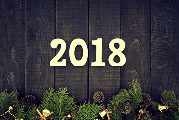 Wall Mural - Composition with decorated Christmas tree and number 2017 as a symbol of the coming New Year on a rustic wooden background. Holiday greeting card. Top view