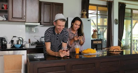 Sticker - Couple Use Cell Smart Phones, Young Woman And Man In Kitchen Studio Chatting Online Modern House Interior Slow Motion 60