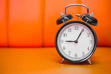Retro Style Bell Clock In The Morning On Orange Background