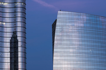 Modern office building with glass facade at dusk