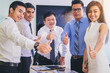 © Panumas - business team showing thumbs up for stock exchange in office. team work concept