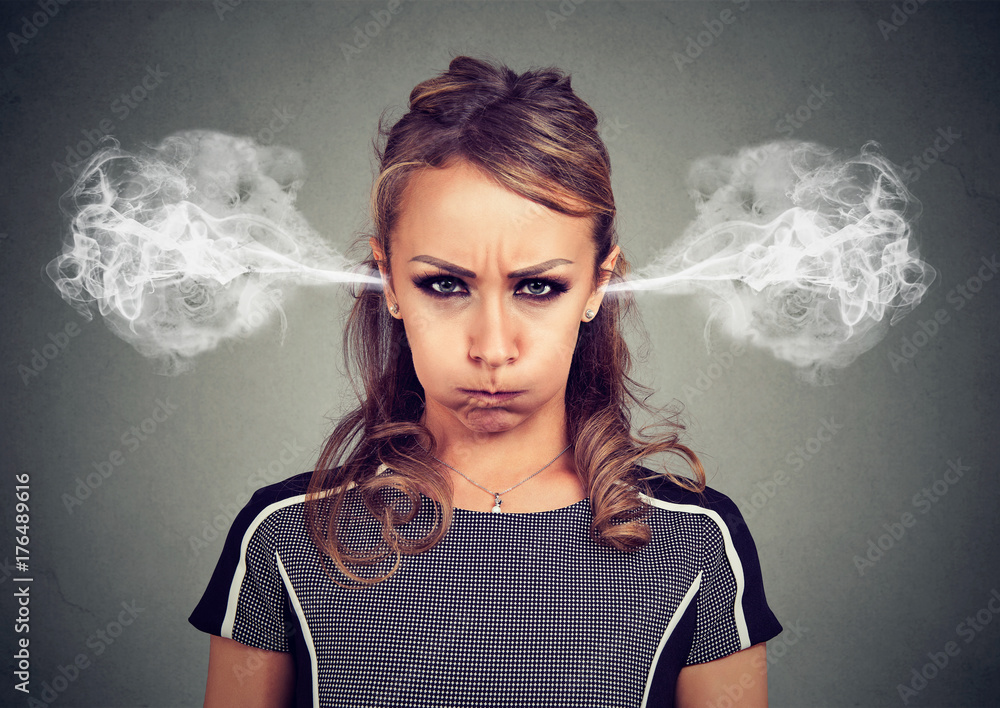 Closeup portrait of angry young woman, blowing steam coming out of ears  Stock Photo