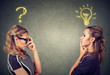 Two women thinking one has a question another solution with light bulb above head
