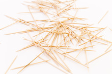 Close-up Of A Pile Of Wooden Toothpicks On White Background