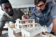 © Jacob Lund - Two architects making architectural model in office