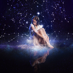 Photo art, young woman dreams to starry sky. Elements of this image furnished by NASA.