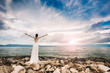 © Laszlo - Wedding at the beach. Island wedding. Beautiful bride standing with open arms.  Relaxed woman enjoying sun, freedom and life an beautiful beach in sunset. Young lady feeling free, relaxed and happy.
