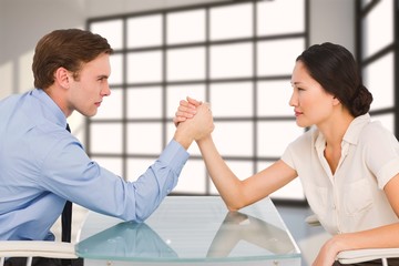 Sticker - Composite image of business couple arm wrestling at desk