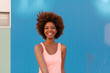 © victortorres/Stocksy - Latin American Afro Woman Against a Blue Background in a Summer Day