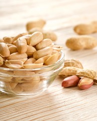 Wall Mural - salted peanuts on wooden background