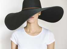 Young Woman Wearing A Big Black Hat