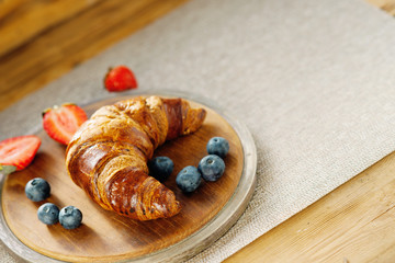 Wall Mural - Fresh croissant and berries 