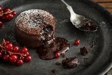 Chocolate Lava Cake With Gooey Molten Center Pouring On To Plate