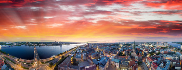 Wall Mural - Riga, Latvia. City skyline and river at night - Aerial view