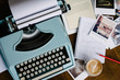 © Gillian Vann/Stocksy - A blue retro vintage typewriter surrounded by the inspiration of writing, with coffee