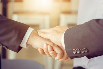 Business partnership meeting concept. Close-up of Successful businessmen handshaking after good deal.