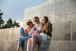 © Jovo Jovanovic/Stocksy - Three girlfriends sitting on the monument having fun