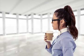 Poster - Composite image of businesswoman holding disposable cup and