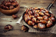 Chestnuts In A Pan On A Wooden Background
