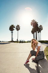 fashionista girl sitting on the broadwalk.