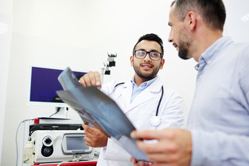 Wall Mural - Two clinicians with x-ray images having discussion in their laboratory