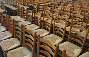 series of empty chairs with straw seat