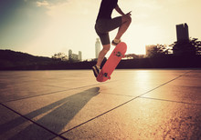Young Woman Skateboarder Skateboarding At Sunrise City