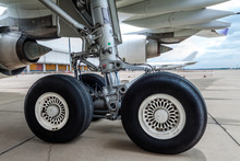 Close Up Of Airplane Wheel Parked At The Airport