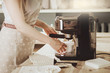 Woman making fresh espresso in coffee maker. coffee machine makes coffee.