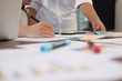 © 88studio - young successful startup team on meeting in office. businessman & businesswoman brainstorm, make a business plan, work on tablet with financial and marketing graph and chart