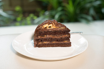 Wall Mural - banana caramel chocolate cake. tasty delicious dessert on white plate. homemade bakery pastry