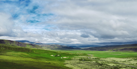 Wall Mural - Travel to Iceland. beautiful mountain landscape in Iceland. Icelandic landscape with mountains, blue sky and green grass on the foreground.