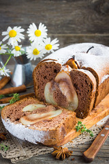 Wall Mural - Vanilla cake with pears, cinnamon, thyme on a wooden table.