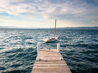 Wall Mural - Pier at Geneva Lake with a sail boat in France