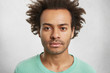 © wayhome.studio  - Portrait of dark skinned confident man with curly Afro hairstyle has calm face expression, looks directly at camera, being ready for serious conversation with employer, isolated over white background
