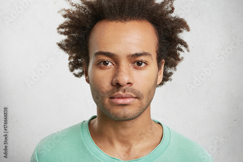 Portrait Of Dark Skinned Confident Man With Curly Afro Hairstyle