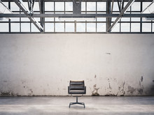 Black Chair At An Abandoned Factory. 3d Rendering