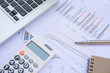 © Achira22 - Office Concepts : data analyzing with calculator,laptop,notebook and pen. on charts and graph to find out the result.