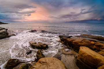 Wall Mural - Colorful sunrise against stormy clouds in San Diego, California