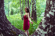 © allenkayaa - Pretty girl in red dress in a summer forest in the mountains