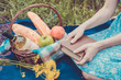 © allenkayaa - Picnic in nature at summer, basket with food. Young woman with a book