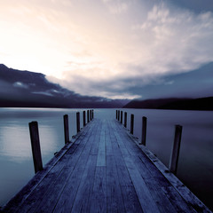 Sticker - Boat jetty and a calm lake at sunrise, New Zealand.