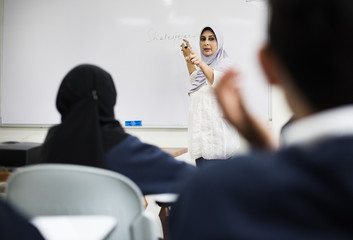 diverse muslim children studying in classroom