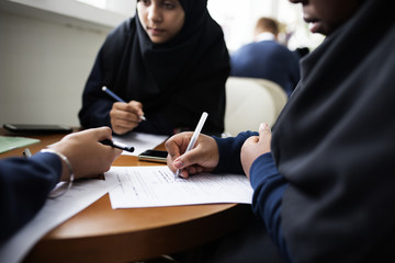 Wall Mural - Diverse Muslim girls studying in a classroom