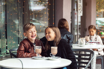 Wall Mural - Children having fun in outdoor cafe