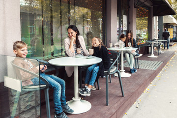 Wall Mural - Family having fun in outdoor cafe