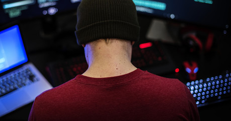 rear view of man working on computer coding program