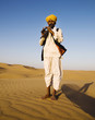 © Rawpixel.com - Indigenous Indian man playing wind pipe in a desert.