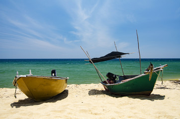 Wall Mural - Beautiful scenery, traditional fisherman boat moored over beautiful sea view and sandy beach under bright sunny day